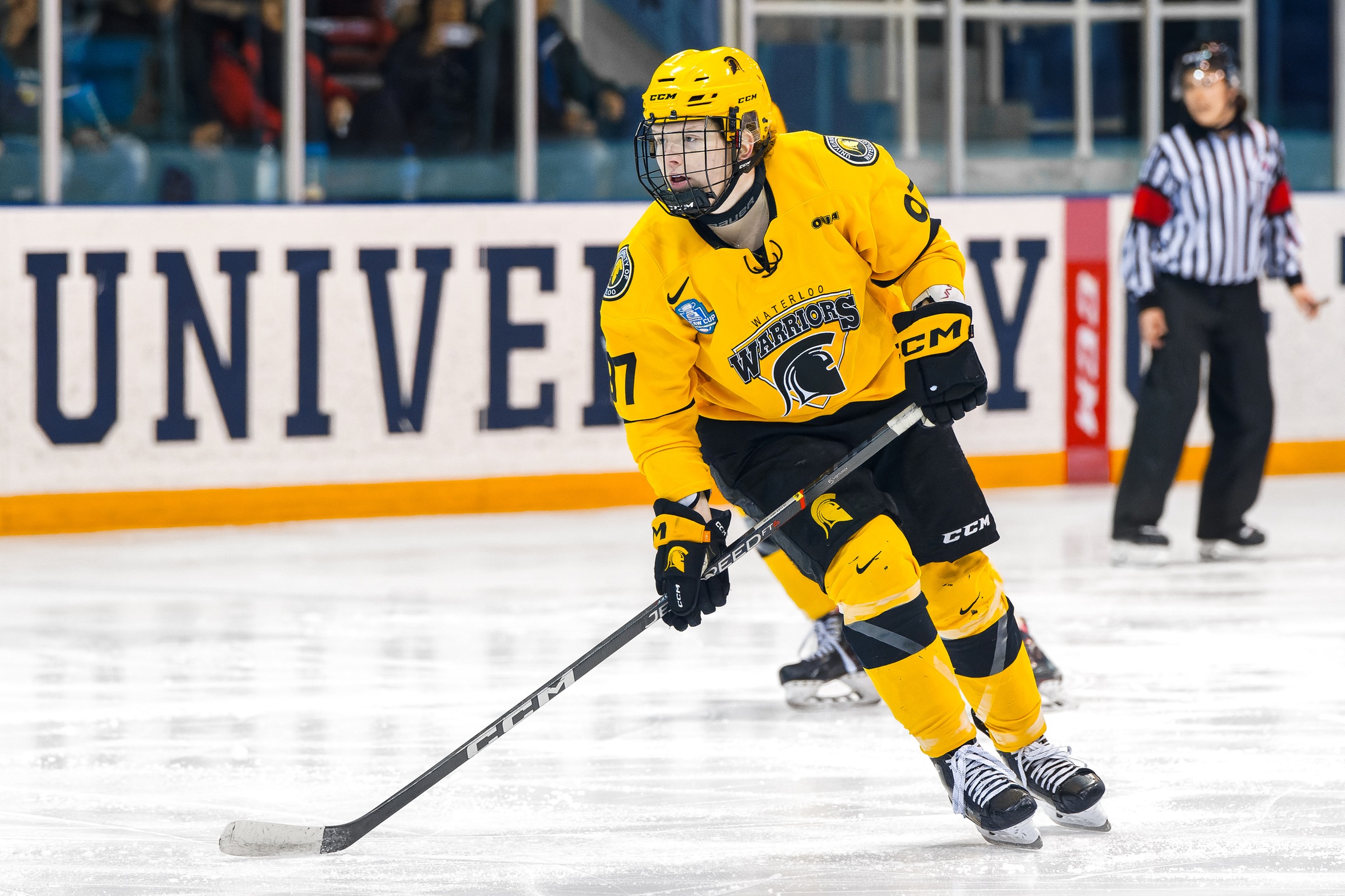 An action photo of Waterloo Warriors hockey athlete Paige Rynne on the ice. 