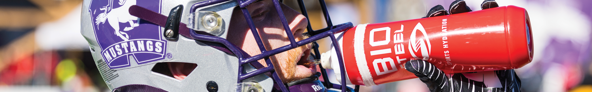Western football player drinking from a BioSteel bottle