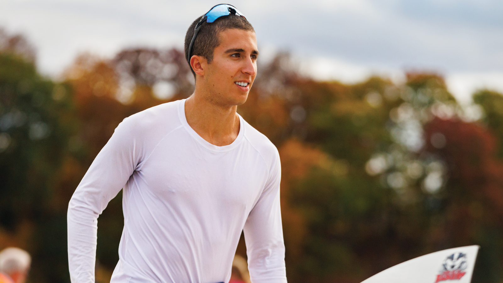 Brock men's rower Charles-Etienne Tabet holding an orr with the Brock Badgers logo on it