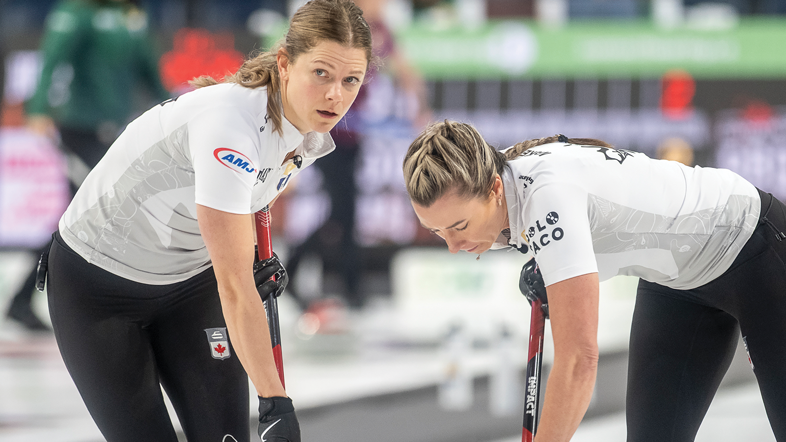 Photo of two Canadian women's curlers sweeping the rock