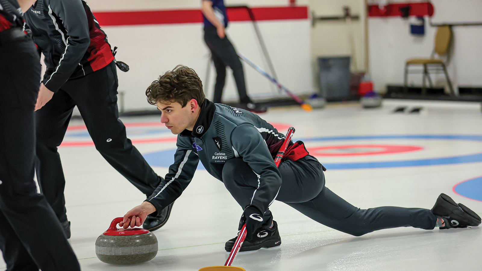 Action photo of a Carleton Ravens men's curler