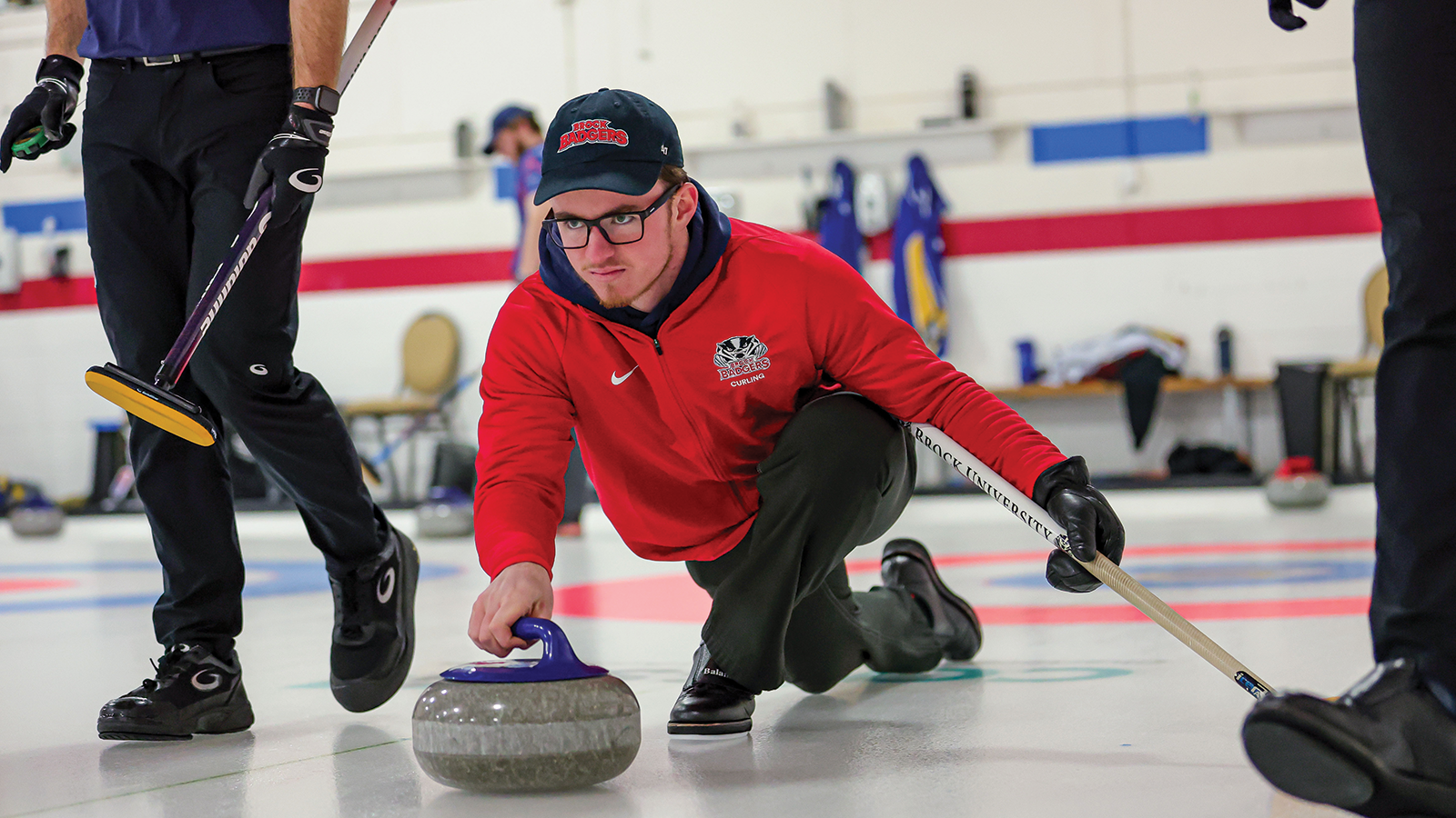 Action photo of a Brock Badgers men's curler 