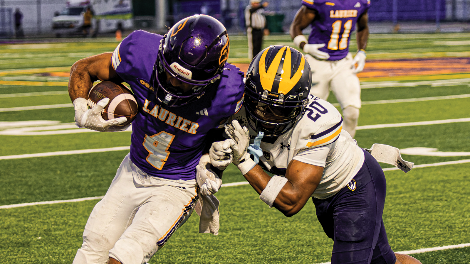 Action photo of a Laurier Football player and a Windsor football player 