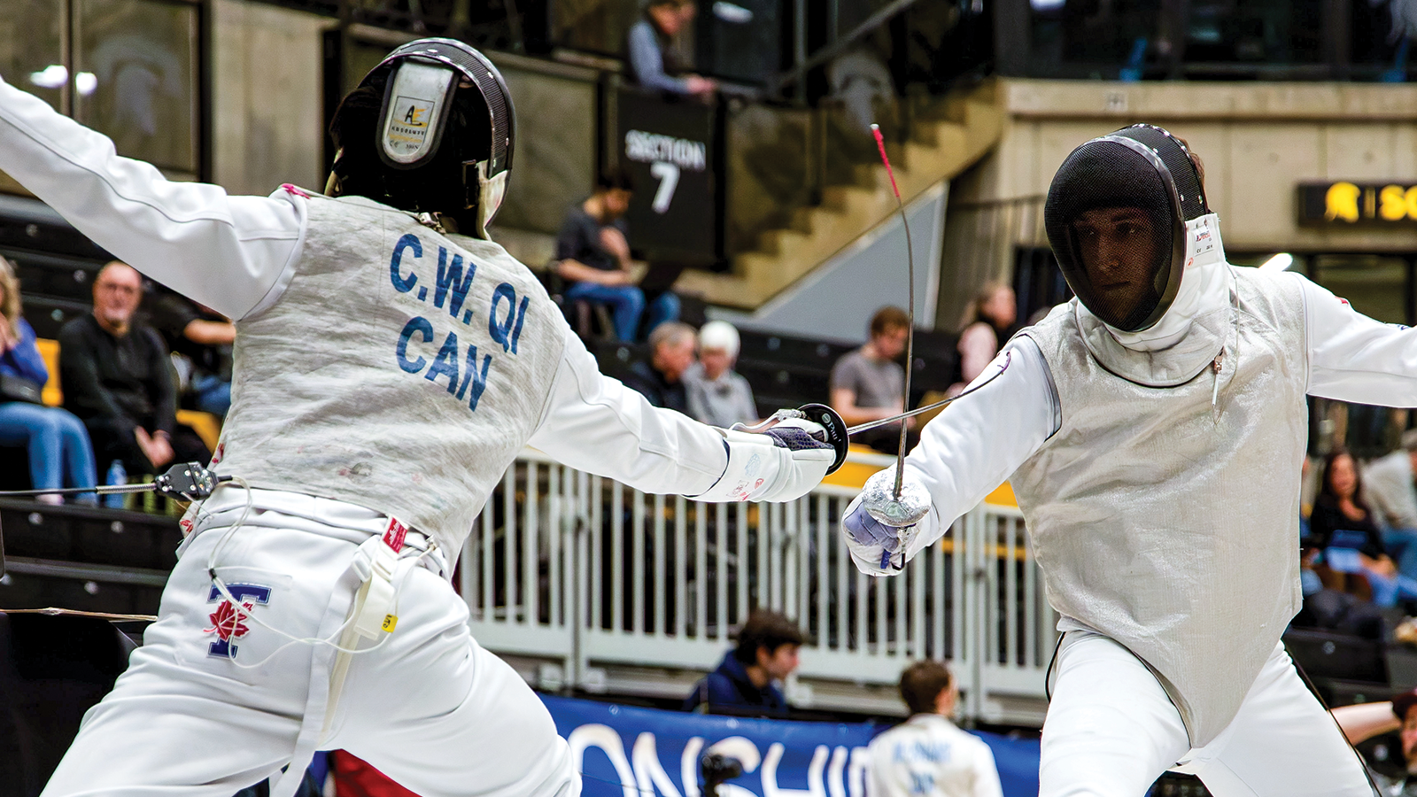 Action photo of two men's fencers fencing each other