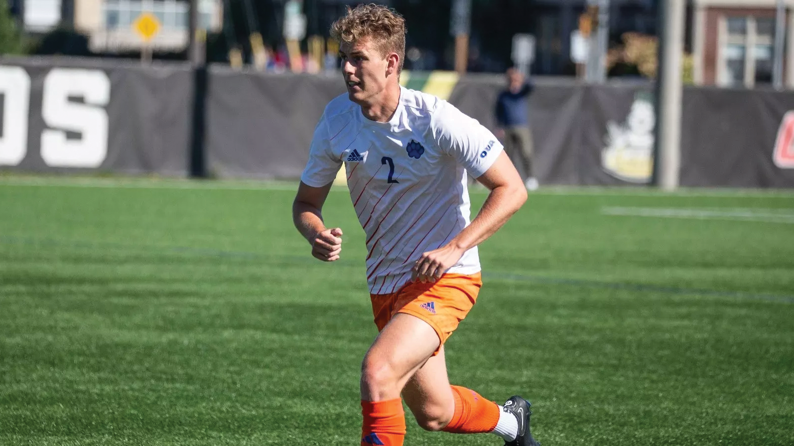 Ontario Tech men's soccer player running on the field during a game